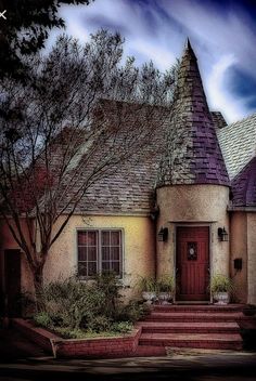 a house with a red door and steps leading up to it