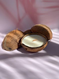 coconuts and a candle on a white sheet