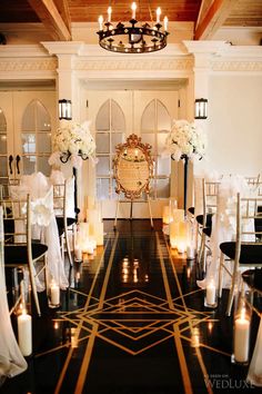 the ceremony room is decorated with white flowers and candles