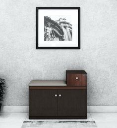 a black and white photo hanging on the wall next to a cabinet in a living room