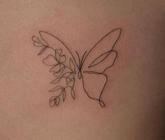 a small butterfly tattoo with flowers on it's back side ribcadings