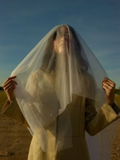 a woman wearing a veil in the desert