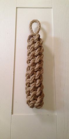 a piece of rope hanging on the wall with a hook in it's center