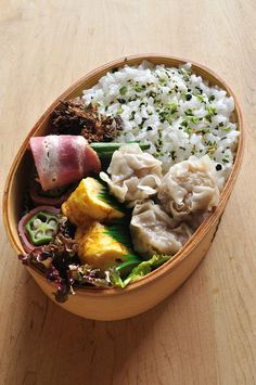 a wooden bowl filled with different types of food