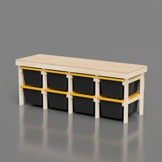 a wooden table with black and yellow bins on the bottom, against a gray background