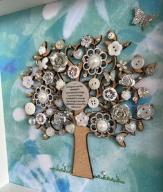 a tree made out of buttons with a plaque on it