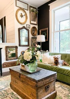 a living room filled with lots of furniture and pictures on the wall above it's fireplace