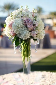 a vase filled with white and pink flowers