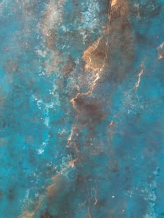 an aerial view of the ocean with blue water and brown sand on it's surface