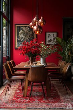 a dining room with red walls and wooden table surrounded by chairs, potted plants and hanging lights