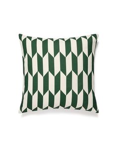 a green and white pillow on a white background