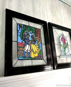 two framed stained glass panels on the wall