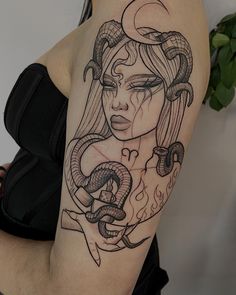 a woman with a snake tattoo on her arm