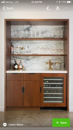 a kitchen with marble counter tops and wooden cabinets on the wall above it is an appliance for wine glasses