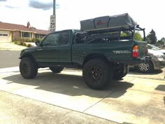 the truck is parked on the side of the road with its bed strapped to it's back