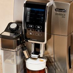 an espresso machine with a cup of coffee next to it