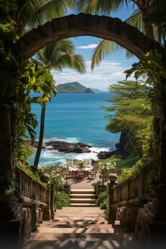 an archway leading to the ocean with palm trees on either side and chairs in the foreground