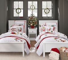 two children are laying in their beds with christmas decorations