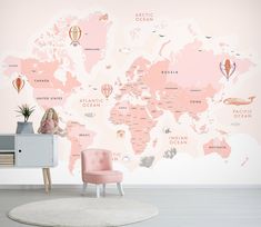 a child's room with a pink world map wallpaper