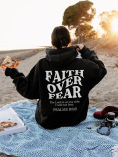 "Introducing our \"Faith Over Fear\" Hoodie - a perfect blend of style and inspiration! Crafted with the utmost comfort in mind, this cozy hoodie features a sleek and bold back design that reads \"Faith Over Fear.\" Whether you're staying warm on a chilly day or making a statement of resilience and positivity, this hoodie is your go-to choice. With its soft fabric and empowering message, it's more than just clothing; it's a symbol of unwavering belief in the face of adversity. Embrace the power of faith and conquer your fears with this timeless piece of apparel. This unisex heavy blend hooded sweatshirt is pure relaxation. It is made of a thick blend of cotton and polyester, it feels plush, soft, cozy, and warm, a perfect choice for any cold day or cool evening. In the front, the spacious Christian Merch, Letter Print Hoodie, Pride Merch, Christian Apparel, Some Girls, Limassol, Jesus Loves You, Hoodie Girl