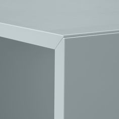 a close up view of the corner of a white table with no one on it