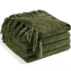 a stack of green towels folded on top of each other