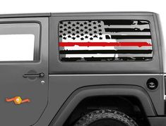 an american flag on the side of a gray jeep with thin blue line decals