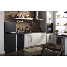 a black refrigerator freezer sitting inside of a kitchen