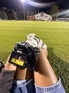 a person sitting on the grass with a camera