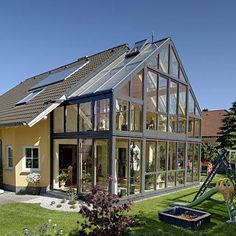 a large house with lots of windows on the roof