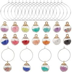 a bunch of wine glasses with different colored beads on them and some metal hangers