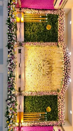 an overhead view of a wedding ceremony with flowers on the ground and candles lit up