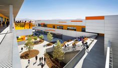 an aerial view of the outside of a building with people walking around