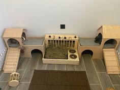 a cat house with two beds and three cats in it's cages on the floor