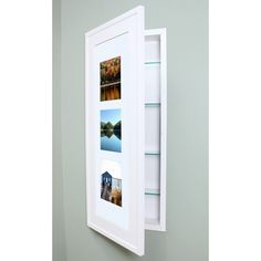 a white frame with pictures hanging on the wall