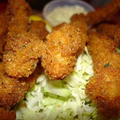 some fried food is on a plate with coleslaw