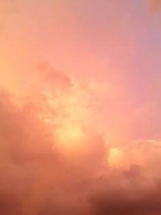 an airplane is flying high in the sky at sunset or dawn with clouds behind it