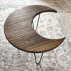 a wooden table sitting on top of a carpet covered floor next to a white rug