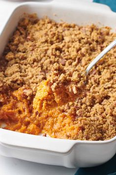 Close-up of a sweet potato casserole in a white baking dish with a golden pecan crumble topping and a spoon scooping a creamy portion. Ruth Chris Sweet Potato, Ruth Chris Sweet Potato Casserole, Ruths Chris Sweet Potato Casserole, Vegan Sweet Potato Casserole, Butternut Squash Casserole, Best Sweet Potato Casserole, Sweet Potato Souffle, Ruth Chris, Pecan Topping