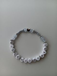 a white beaded bracelet with the word grandma on it