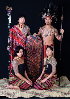 three people in native clothing posing for a photo