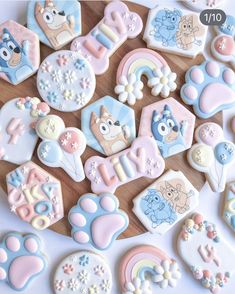 decorated cookies are arranged on a cutting board