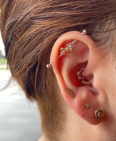 a person with some piercings on their ear