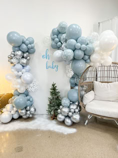 balloons are arranged in the shape of letters and snowflakes, with a christmas tree next to them