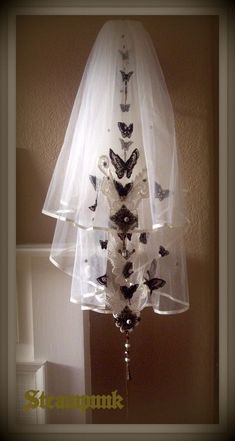 a wedding veil with butterflies attached to it