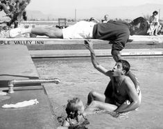 two men are in the water playing with each other