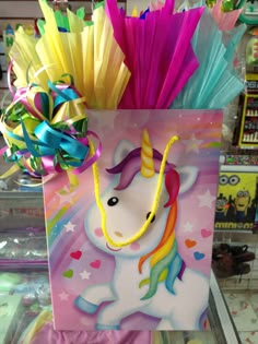 a bag with a unicorn on it and some colorful streamers in the back ground