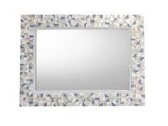 a mirror that is sitting on top of a wall with blue and white mosaic tiles