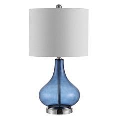 a blue glass table lamp with a white shade on the base and a silver metal base