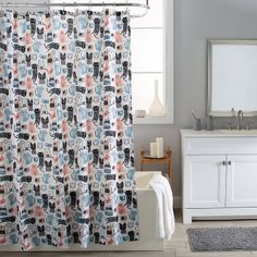 a shower curtain with cats on it in a bathroom next to a sink and mirror